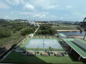 an aerial view of a tennis court and a lake at Del Mare Bangsaley condo in Bang Sare