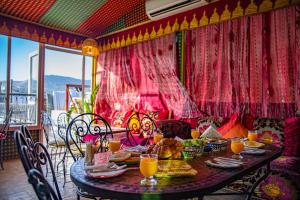 a table with food and orange juice on a balcony at Dar Amireal Fez in Fez