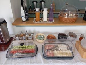 a kitchen counter with some food in trays on it at Dina Apartments Kokkari, Pension Dina, Dina Rooms in Kokkari