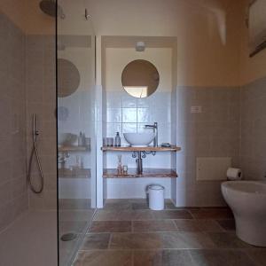 a bathroom with a sink and a toilet and a shower at B&B La RU in Montemagno