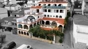 a large white house with a red roof at Irene Bed & Breakfast Tisno in Tisno