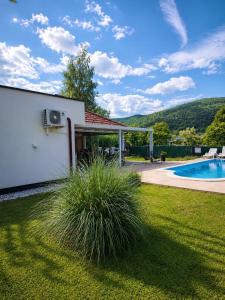 a backyard with a pool and a house at Crystal Račić in Bihać