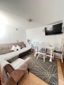 a living room with a couch and a table at Casa Kraljevo in Kraljevo