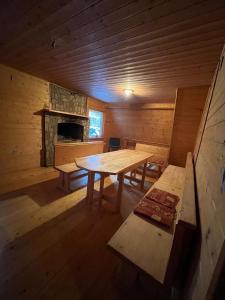 a wooden room with a table and a fireplace at Vikendica Lovinovic Vlasic in Šišava
