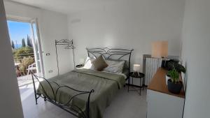 a bedroom with a bed and a balcony at Alpina Sanico in Toscolano Maderno