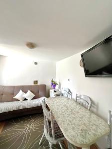 a living room with a table and a couch at Casa Kraljevo in Kraljevo