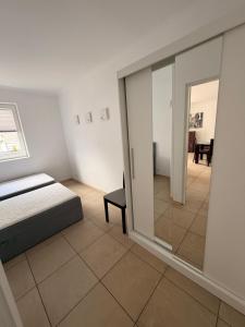 a bedroom with a bed and a sliding glass door at Słoneczne Ranczo Rowy in Rowy