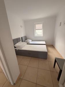 a small bedroom with a bed and a window at Słoneczne Ranczo Rowy in Rowy
