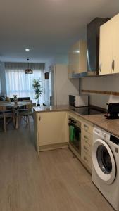 a kitchen with a washer and dryer in a room at Apartamentos FELIP 2 in Burriana