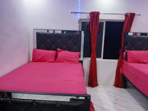a bedroom with a bed with pink sheets and a window at Skyview Palace in Montpelier