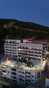 an aerial view of a large apartment building with a pool at Apartments Mekic in Utjeha