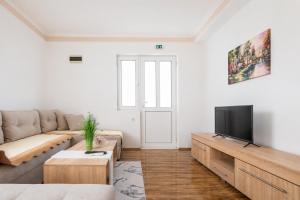 a living room with a couch and a tv at Markovi A&V in Gevgelija