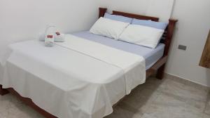 a bed with a stuffed animal sitting on top of it at Hotel Panther Resort in Necoclí