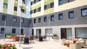 a courtyard with tables and chairs in front of a building at StepHouse Pamplona in Pamplona