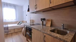 a kitchen with a sink and a bed in a room at StepHouse Pamplona in Pamplona