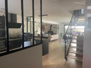 a living room with a staircase and a house at Maison de vacances à Bordeaux in Le Haillan