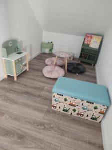 a childs room with a crib and a table at Domki u Ewy in Spychowo