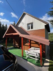 a house with a picnic table in front of it at House Bozovic in Žabljak