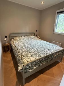 a bed in a room with a bed frame at Bos chalet Hellendoorn met Hottub in Haarle
