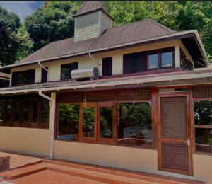 a house with large windows and a roof at coubaril Manor in Castries