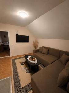a living room with a couch and a table at HERC domaćinstvo in Nova Varoš