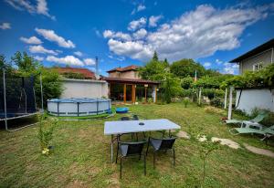 a picnic table in the yard of a house at Guest House Devetaki in Devetaki