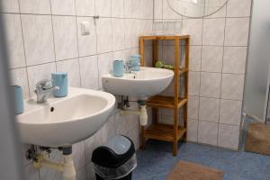 a bathroom with two sinks and a mirror at Hotýlek pod smrkem in Harrachov +88 photos