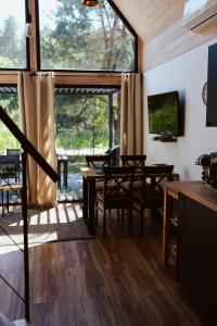 a living room with a table and chairs and a tv at Sasinko Mini in Sasino