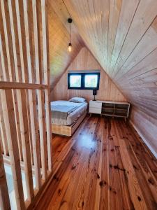 a bedroom with a bed in a wooden ceiling at Sasinko Mini in Sasino