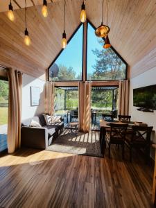 a living room with a large window and a table at Sasinko Mini in Sasino