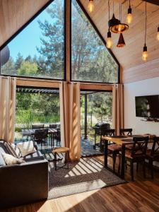 an open living room with large windows and a table at Sasinko Mini in Sasino