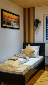 a bedroom with a bed with a blanket on it at Chalet du calme Augsburg in Augsburg