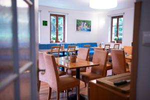 a dining room with wooden tables and chairs at Hotýlek pod smrkem in Harrachov