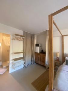 a bedroom with a bed and a microwave in it at Chambre cosy in Viols en Laval