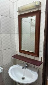 a bathroom with a sink and a mirror at SWISS Residence Denver in Douala +18 photos