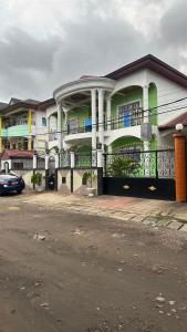 a building with a car parked in front of it at SWISS Residence Denver in Douala