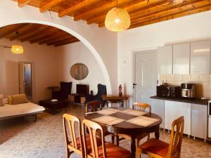 a kitchen and dining room with a table and chairs at Divine Island Escape in Kini