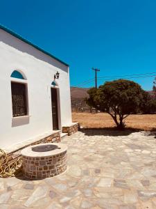 a small white church with a tree in front of it at Divine Island Escape in Kini