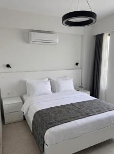 a white bedroom with a large bed with white pillows at Aera Villas - Kaş in Kaş +20 photos