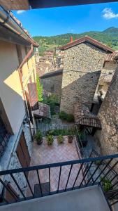 an external view of a balcony with chairs and a building at Residenze del Borgo in Zavattarello