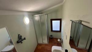 a bathroom with two toilets and a glass shower at Residenze del Borgo in Zavattarello