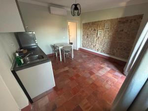 a kitchen with a sink and a table in a room at Residenze del Borgo in Zavattarello