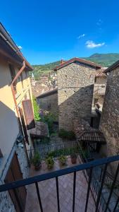 a balcony of a building with potted plants on it at Residenze del Borgo in Zavattarello +103 photos