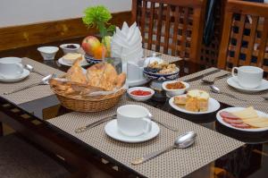 a wooden table topped with plates of food at Jipek Joli Inn in Nukus