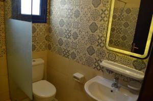 a bathroom with a toilet and a sink at Pool View Chalet in El Alamein +3 photos