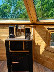 a small stove in a room with a window at Kota Évasion & Spa in Cahors +2 photos