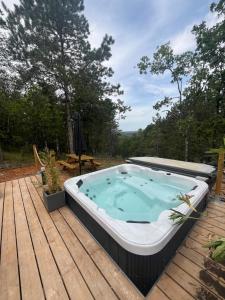 a hot tub sitting on a wooden deck at Kota Évasion & Spa in Cahors