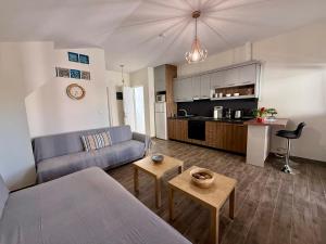 a living room with a couch and a kitchen at Sonia in Leptokarya +18 photos