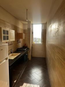 a small kitchen with a sink and a window at Ouzoud le Panorama in Ouzoud