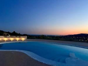 a swimming pool at night with a view at Villa Marchesa in Castelnuovo Cilento